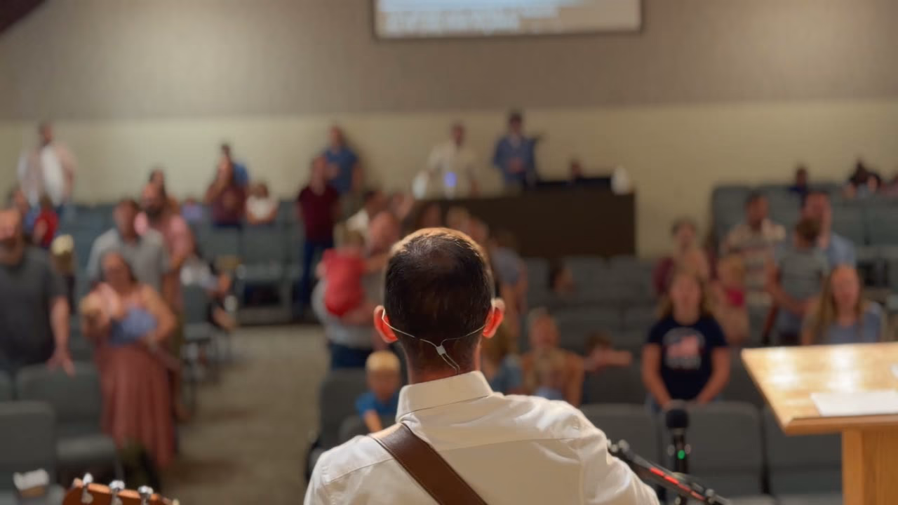 The congregation standing to sing during Sunday worship at Clearnote Church.